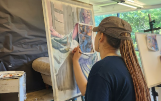 Student in class painting a figure